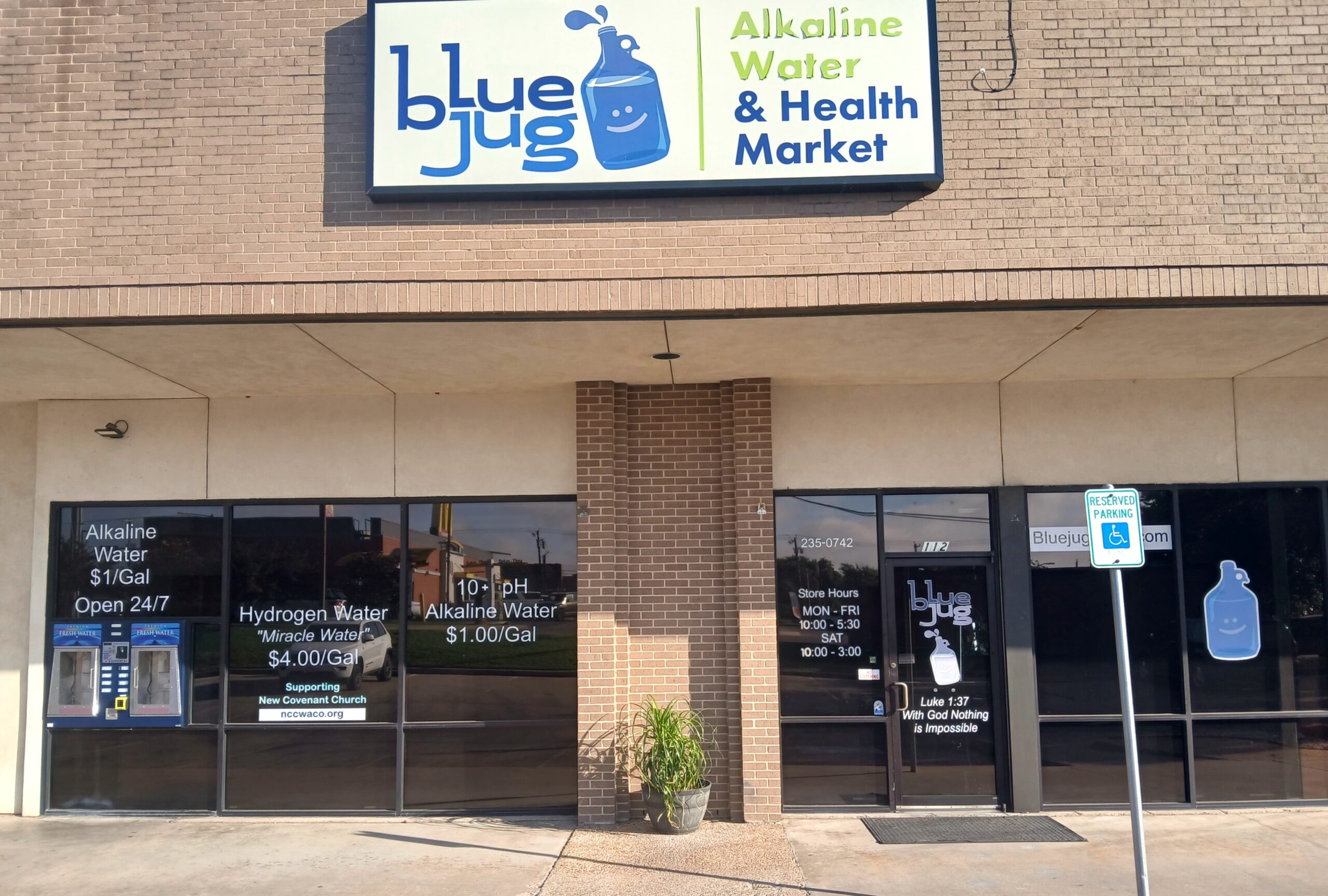 Exterior storefront of Blue Jug Waco showing the "Alkaline Water & Health Market" sign and 24/7 self-service water refill stations.